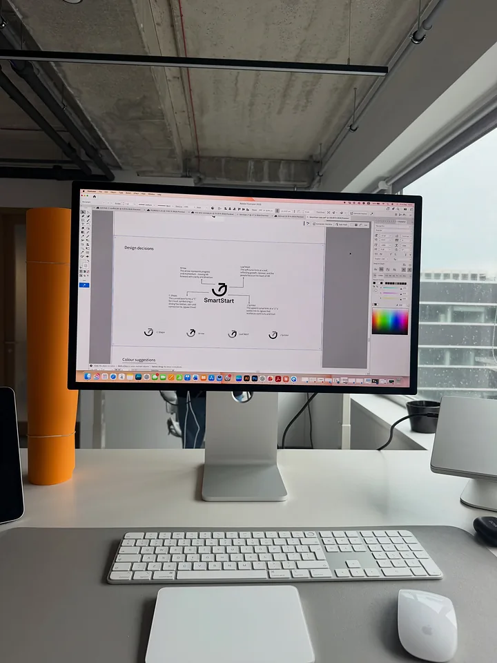 SmartStart logo design decisions on the studio computer